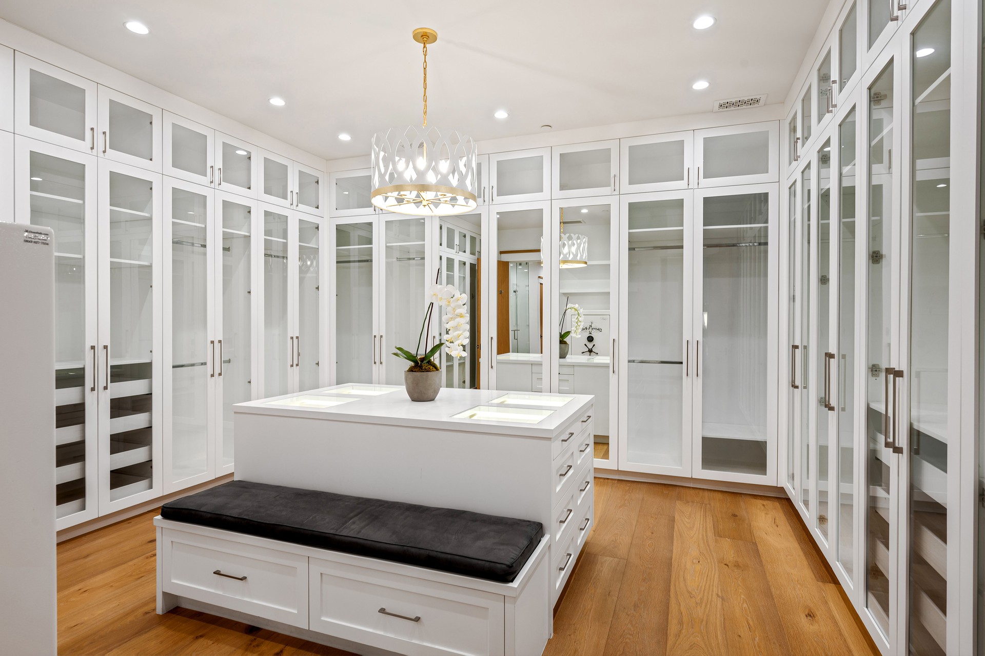 a kitchen with a island on top of a wooden floor