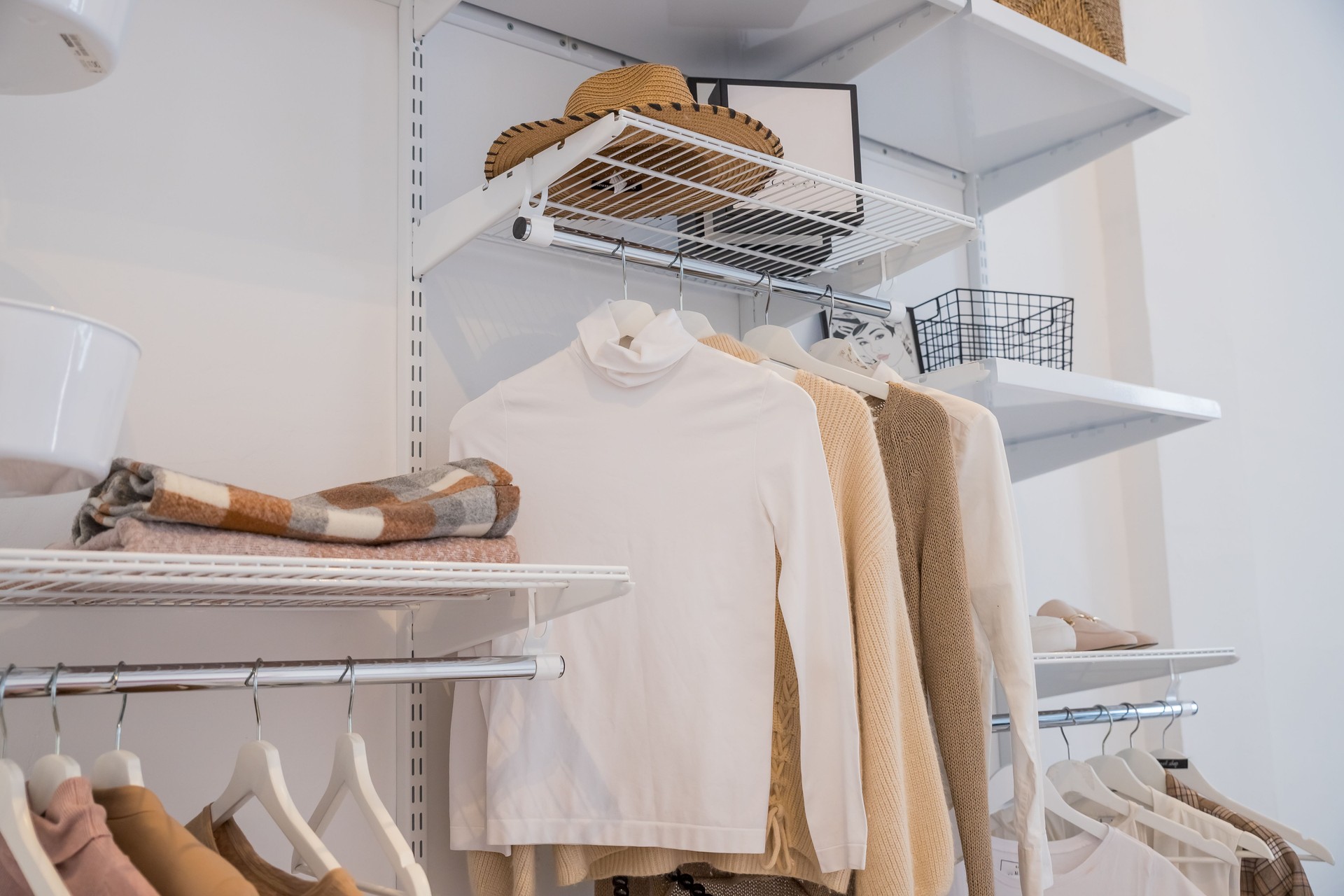 Interior of show room with stylish clothes and accessories.Collection of female clothes hanging on rack in dressing room. room interior with clothing rack